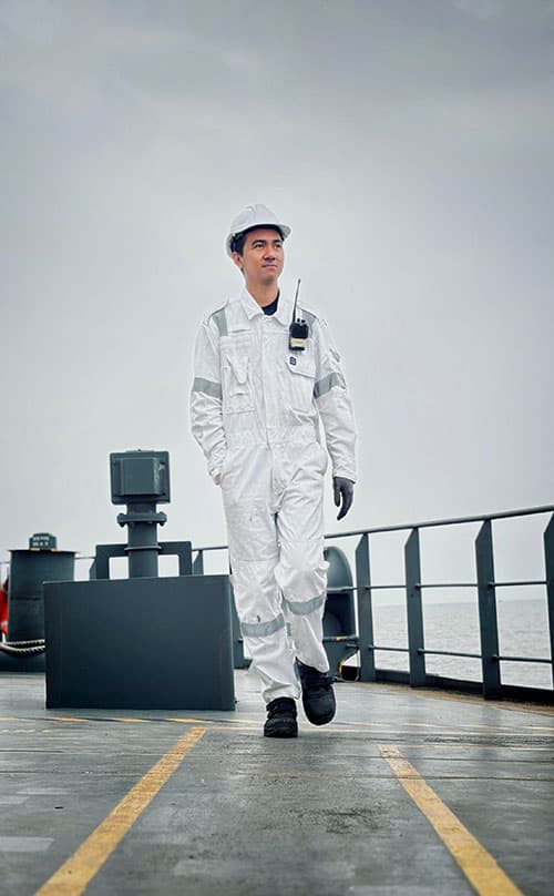 Northstar cadet standing on ship deck at sunrise