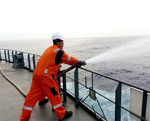Cadet performing deck duties aboard a cargo vessel
